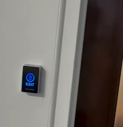 Illuminated exit button on a wall
