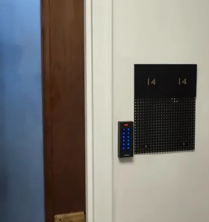 Keypad access reader beside a door