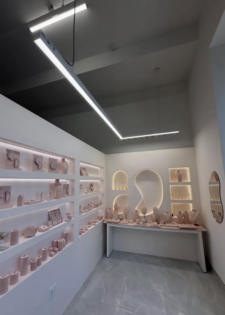 Linear lighting above a retail display wall